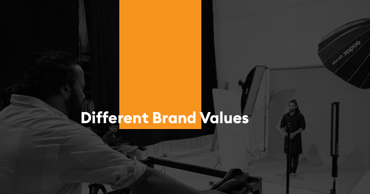 Photography studio scene with lighting equipment and crew members, featuring the title “Different Brand Values.